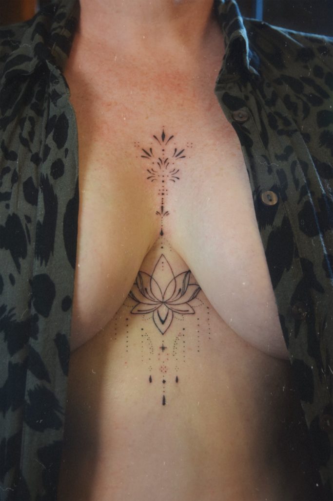 Tatouage underboob ornemental avec un lotus.